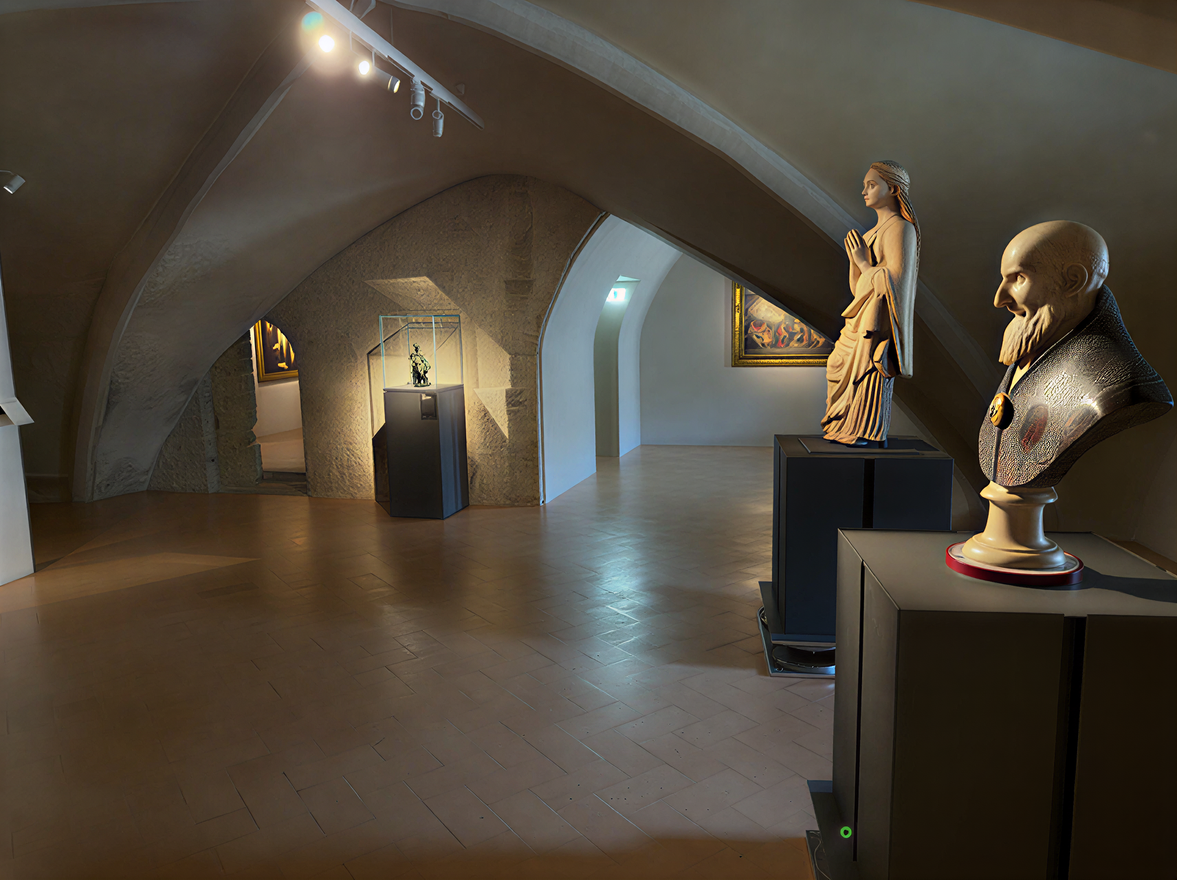 Intérieur de la Galleria Nazionale dell'Umbria montrant des sculptures et des bustes dans un cadre architectural historique.