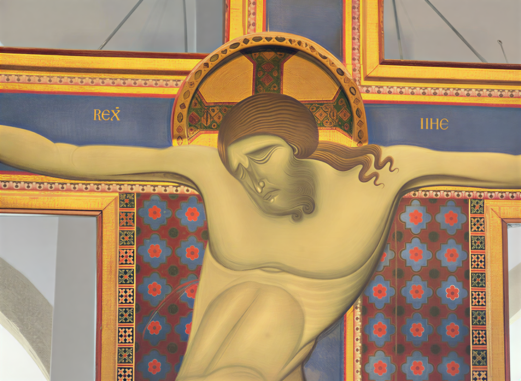 Détail d'une œuvre représentant le Christ en croix, illustrant la Renaissance italienne avec des couleurs vibrantes et un réalisme poignant, mettant en avant la souffrance et la rédemption.